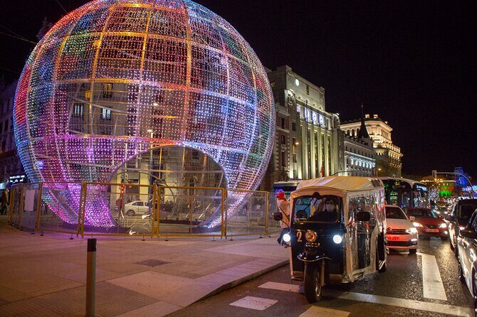 Christmas Lights Tour of Madrid in Eco Tuk Tuk Private - Plaza de Colón and the Columbus monument: lights over a 17-meter landmark